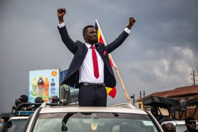 Bobi Wine with his hands up