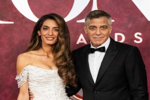 George Clooney and Amal Clooney, celebrity couple, attending a red carpet event, showcasing their style and influence.