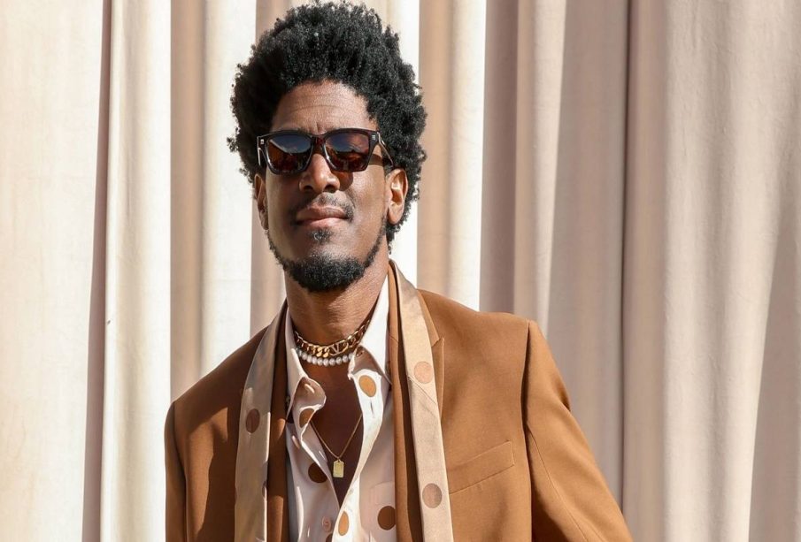 Labrinth in an event wearing a brown jacket