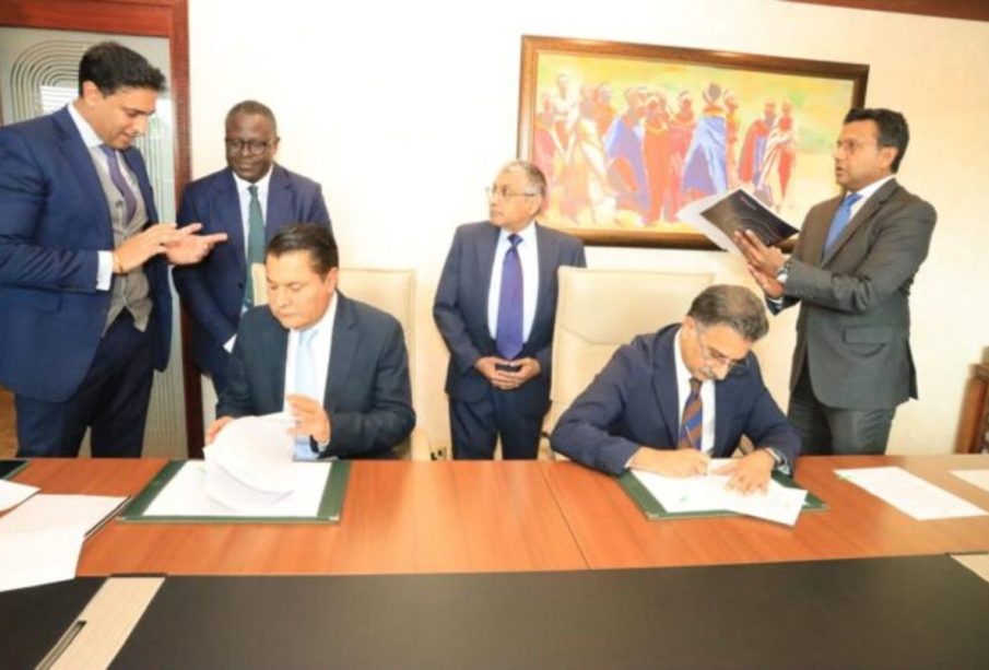 Tanzanian billionaire Rostam Aziz, signing documents