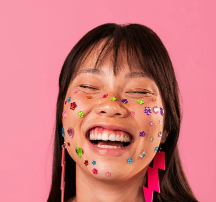 Young woman confidently wearing star-shaped acne patches as part of her beauty look