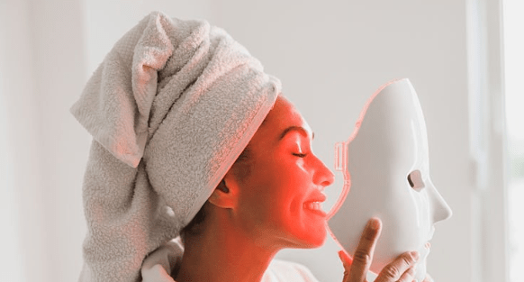 Person wearing an LED light therapy mask during an at-home skincare routine