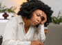a lady staring at her laptop tired