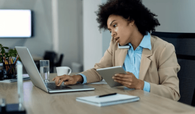 a lady in an office answering a call and typing