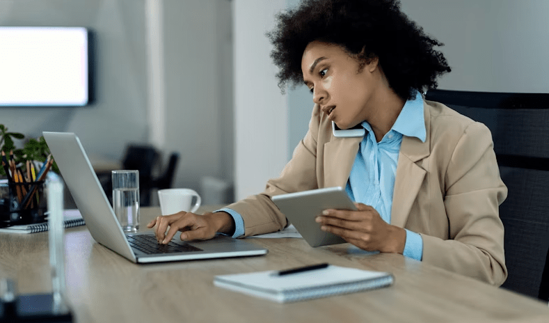 a lady in an office answering a call and typing