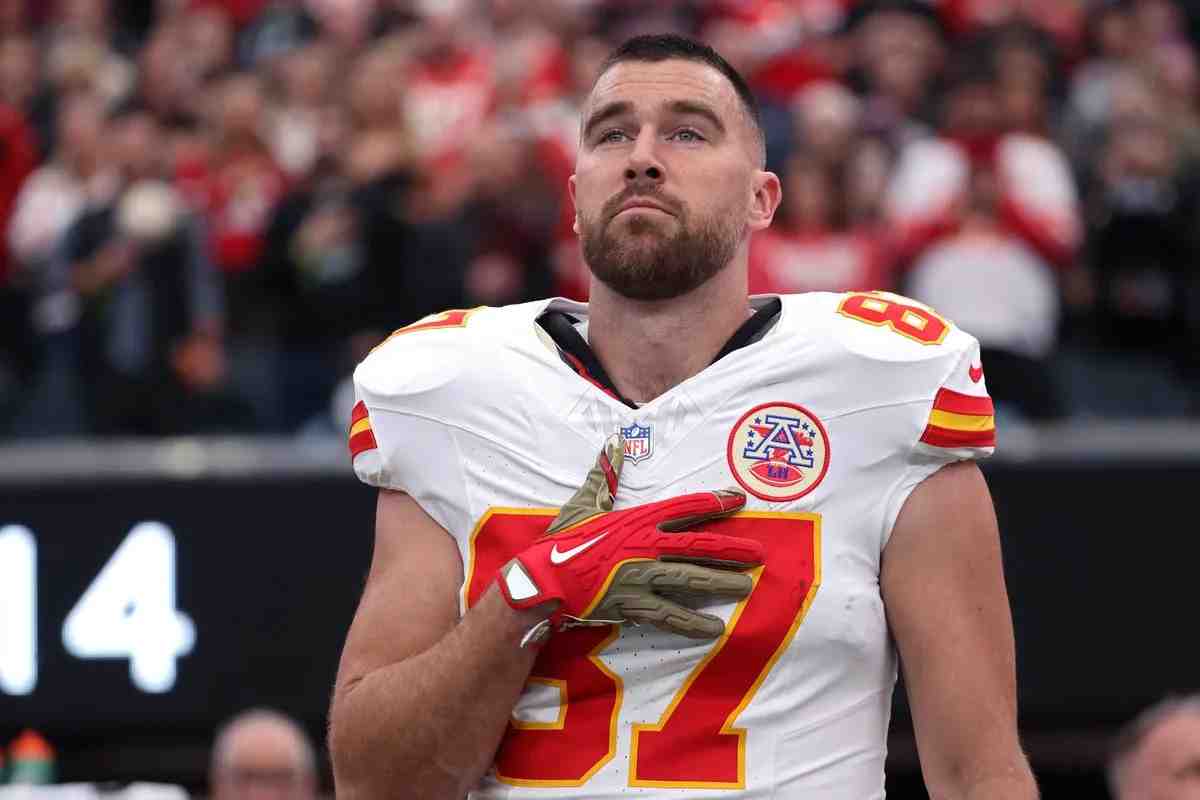 Travis Kelce with his hand on his chest