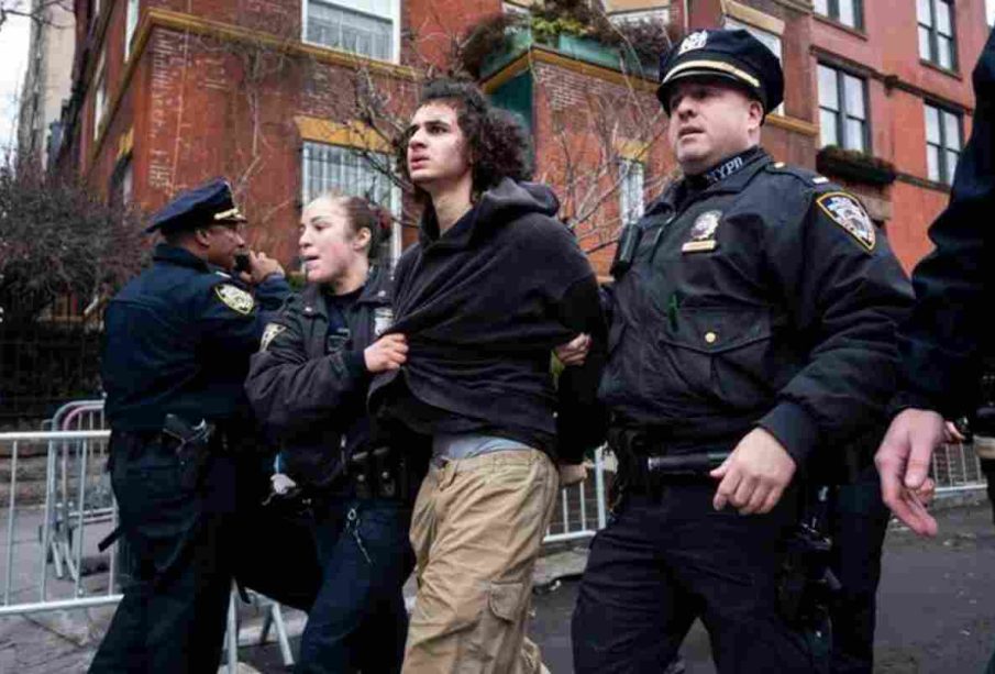 A teenager led by the police in the Two teenagers face charges over an alleged bomb attempt during a protest in New York, raising fresh concerns about security and a possible New York terror threat.