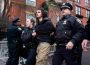 A teenager led by the police in the Two teenagers face charges over an alleged bomb attempt during a protest in New York, raising fresh concerns about security and a possible New York terror threat.