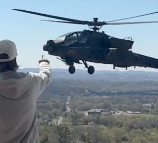 Kid Rock pointing at a military aircraft