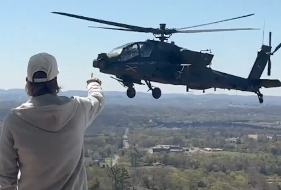 Kid Rock pointing at a military aircraft