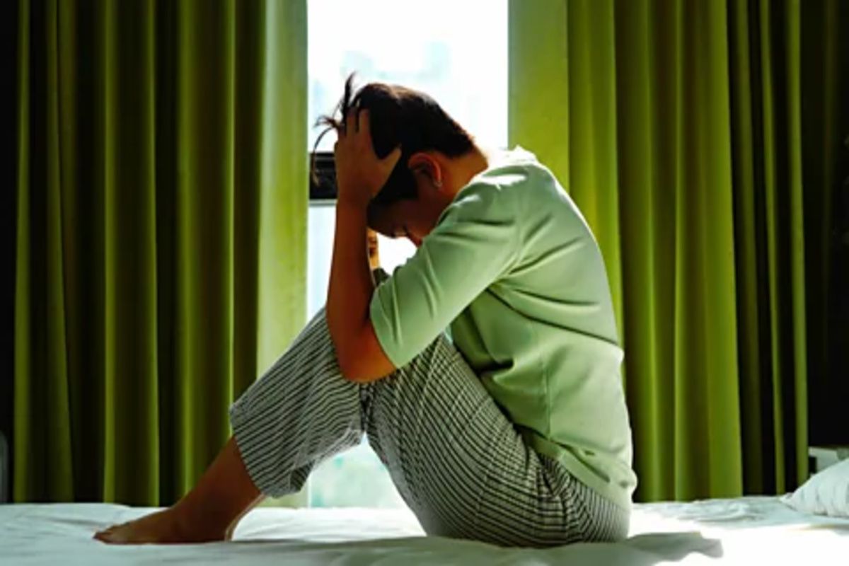 A woman on the bed having a mental breakdown