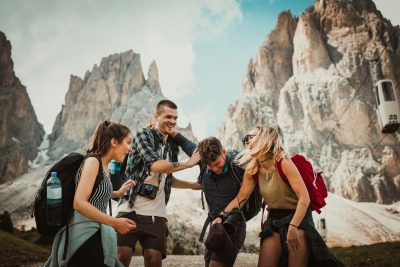 Two men playing beside two women, sharing laughs and moments inspired by budget friendly travel tips.
