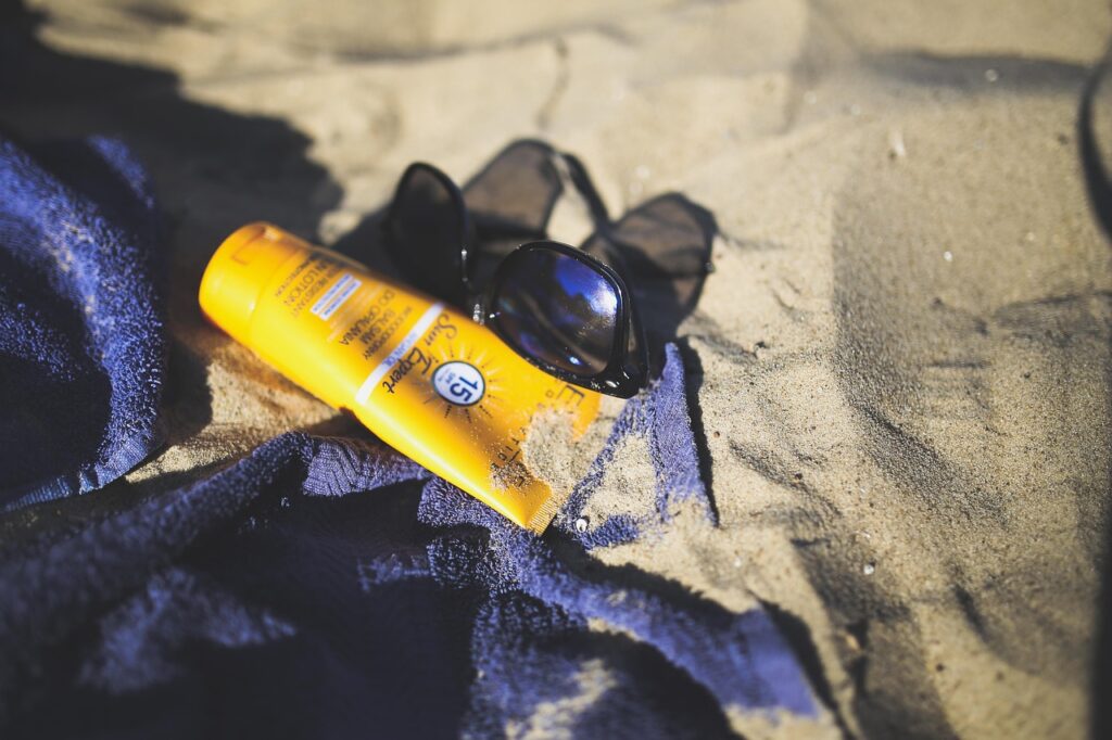 sunscreen lying on the beach sand