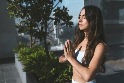 A lady outdoor meditating and journaling