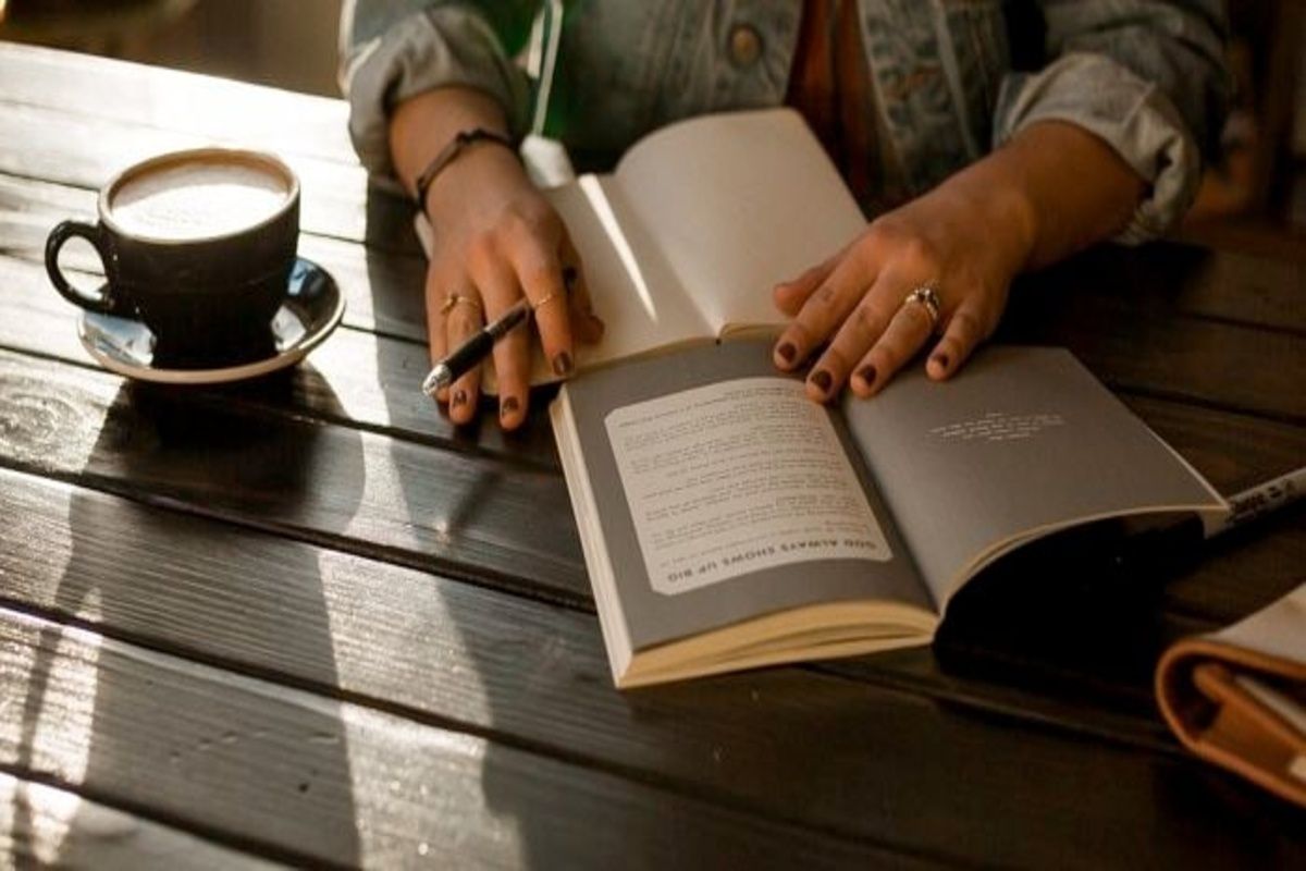 A woman reading and journaling as on of the mental health practices