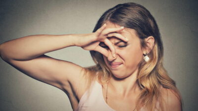 A woman covering her nose with her hands