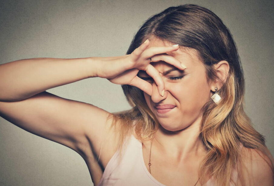 A woman covering her nose with her hands