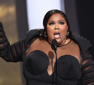 Lizzo giving a speech on stage